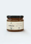 Jar of Lebfarms cedar honey on a white background